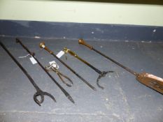 A WROUGHT IRON POKER AND FIRE FORK WITH RAMS HEAD HANDLES TOGETHER WITH A POKER AND SHOVEL WITH