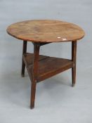 AN OAK CRICKET TABLE, THE THREE PLANK CIRCULAR TOP.