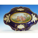A FRENCH PORCELAIN SEVRES STYLE DISH, THE CENTRAL OVAL PAINTED WITH CUPID WITH TWO BACCHIC PUTTI