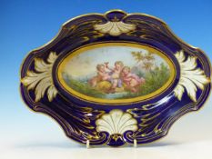 A FRENCH PORCELAIN SEVRES STYLE DISH, THE CENTRAL OVAL PAINTED WITH CUPID WITH TWO BACCHIC PUTTI