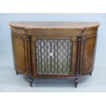 AN INLAID MAHOGANY REGENCY STYLE BREAK BOWFRONT CABINET WITH BRASS LATTICE DOOR. 123 x 40 x 84cms.