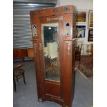 AN ARTS AND CRAFTS LIBERTYS TASTE OAK MIRRORED WARDROBE AND DRESSING TABLE, THE FORMER WITH COPPER