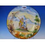 A MAIOLICA PLATE PAINTED WITH A YELLOW ROBED FIGURE STANDING BY A SEATED SOLDIER IN A LANDSCAPE WITH