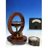 A MAHOGANY MOUNTED MAGNOMETER COMPASS, A UNIVERSAL AVOMINOR RESISTANCE METER IN LEATHER CASE AND A