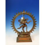 A HINDU COPPER RICH FIGURE OF THE LORD OF THE DANCE NATARAJA BACKED BY A CIRCULAR FLAME MANDALA