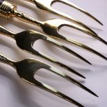 A SET OF FOUR VICTORIAN HALLMARKED SILVER GILT TWO PRONG CARVING FORKS WITH MARBLE HANDLES. DATED