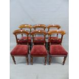 A SET OF SIX VICTORIAN MAHOGANY CHAIRS, ECH WITH BROAD ARCHED TOP RAILS OVER FOLIATE BAR BACKS,