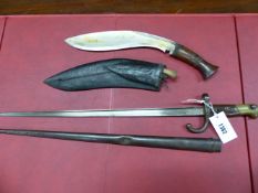 A 19TH CENTURY BAYONET IN STEEL SCABBARD TOGETHER WITH A KUKRI IN LEATHER SCABBARD (2)