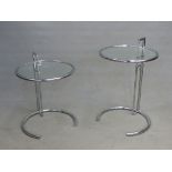 A PAIR OF GLASS TOPPED TUBULAR CHROME TABLES WITH CIRCULAR TOPS, THE PAIRED COLUMNS TO ONE SIDE ON