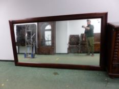 A BESPOKE RECTANGULAR CONTEMPORARY MAHOGANY FRAME MIRROR 259 x 141cms.