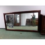 A BESPOKE RECTANGULAR CONTEMPORARY MAHOGANY FRAME MIRROR 259 x 141cms.