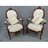 A PAIR OF VICTORIAN FRENCH STYLE WALNUT SHOW FRAME OPEN ARMCHAIRS ON SLENDER CABRIOLE LEGS AND CREAM