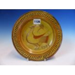 A SLIPWARE BRICK RED POTTERY DISH, THE STRAW COLOURED OVERLAY SGRAFFITO DECORATED WITH A DOVE AND