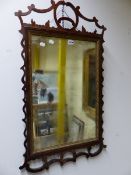 A GEORGE III RECTANGULAR MIRROR WITHIN GILT SLIP AND PIERCED CUT WORK FRAME CRESTED BY A ROUNDEL