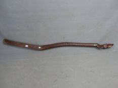 A HARDWOOD BOAT TILLER HANDLE CARVED WITH A DOGS HEAD SCREWS INTO A BRASS RING AT ONE END. W 156cms.