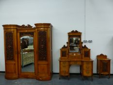 A VICTORIAN WALNUT BEDROOM SUITE, THE DOORS CARVED WITH FRUIT AND SCROLLING FOLIAGE, COMPRISING: A