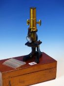 A MAHOGANY CASED BRASS MONOCULAR MICROSCOPE, A FOLD DOWN LENS ABOVE THE BLACKENED STAGE, THE BOX.
