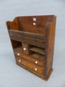 A TRAMP ART PINE WALL CABINET WITH TWO DRAWERS OVER COMPARTMENTS FLANKING THE CENTRAL SMALL