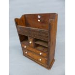 A TRAMP ART PINE WALL CABINET WITH TWO DRAWERS OVER COMPARTMENTS FLANKING THE CENTRAL SMALL