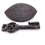 A MEDIAEVAL IRON CASKET KEY. W 5.5cms. TOGETHER WITH A VESSICA SHAPED BRONZE ABBEY SEAL. H 6cms.