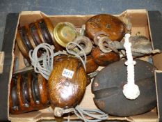 A COLLECTION OF VINTAGE TEAK AND OAK MARITIME PULLEY BLOCKS, A SMALL QUANTITY OF FLAGS AND TWO SMALL