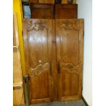 A FRENCH PROVINCIAL PINE ARMOIRE, THE TWO DOORS CARVED WITH FLORAL BANDS AT THE TOPS AND MIDDLE.