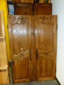 A FRENCH PROVINCIAL PINE ARMOIRE, THE TWO DOORS CARVED WITH FLORAL BANDS AT THE TOPS AND MIDDLE.