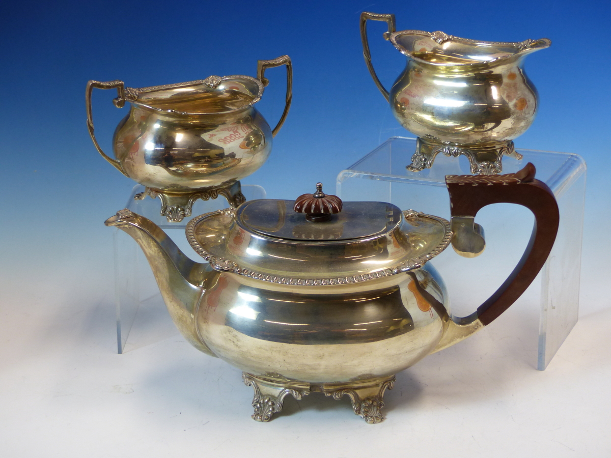 A HALLMARKED SILVER THREE PIECE TEA SET COMPRISING OF A TEAPOT, SUGAR AND CREAMER. DATED 1970