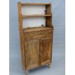 A PINE CABINET WITH THREE WATERFALL SHELVES ABOVE A DRAWER, CUPBOARD AND TURNED LEGS. W62 x D 29 x H
