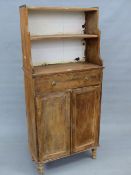 A PINE CABINET WITH THREE WATERFALL SHELVES ABOVE A DRAWER, CUPBOARD AND TURNED LEGS. W62 x D 29 x H