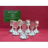 A SET OF EIGHT HALLMARKED SILVER PLACECARD HOLDERS WITH LOADED BASES, DATED 1924 BIRMINGHAM FOR