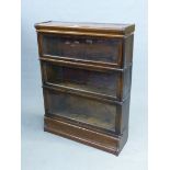 A MAHOGANY GLOBE WERNICKE TYPE BOOKCASE, THE THREE SHELVES WITH GLAZED LIFT UP DOORS. W 86.5 x D