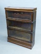 A MAHOGANY GLOBE WERNICKE TYPE BOOKCASE, THE THREE SHELVES WITH GLAZED LIFT UP DOORS. W 86.5 x D