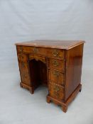 A GEORGIAN WALNUT KNEEHOLE DESK, THE LINE INLAID TOP OVER A LONG DRAWER, THE PEDESTALS EACH WITH