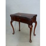 AN ANTIQUE HARDWOOD TRIPLE TOP GAMES TABLE THE RECTANGULAR ROSEWOOD TOP ROUNDED OVER INTERIOR CANDLE