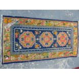 AN ANTIQUE TIBETAN RUG. 145 x 76cms.