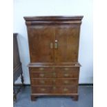 A GEORGIAN BURR WALNUT CABINET ON CHEST, A DRAWER ABOVE THE CABINET DOORS ENCLOSING