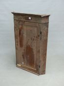 A 19th C. OAK CORNER CUPBOARD WITH FLUTED PILASTERS EITHER SIDE OF THE PANELLED DOOR. W 74 x D 47