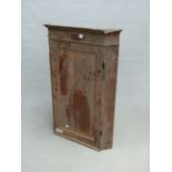 A 19th C. OAK CORNER CUPBOARD WITH FLUTED PILASTERS EITHER SIDE OF THE PANELLED DOOR. W 74 x D 47
