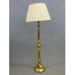 A GILT WOOD STANDARD LAMP, THE COLUMN TURNED AND ON CIRCULAR FOOT. H 150cms.