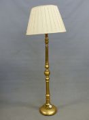 A GILT WOOD STANDARD LAMP, THE COLUMN TURNED AND ON CIRCULAR FOOT. H 150cms.