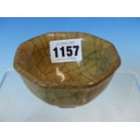 A CHINESE CRACKLE WARE OCTAGONAL BOWL, THE CRACKLES TINTED IN TWO TONES OF BROWN AGAINST THE