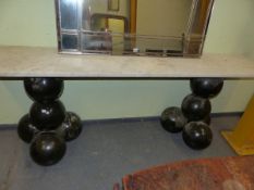 AN UNUSUAL MARBLE TOP CONSOLE TABLE ON STACKED BALL SUPPORTS. 207cm x 38cm x H 76cm.