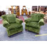 A PAIR OF VINTAGE GREEN VELVET UPHOLSTERED ARMCHAIRS ON LATER CASTOR FEET