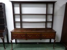 AN 18TH C. AND LATER OAK THREE DRAWER DRESSER WITH OPEN THREE SHELF BACK AND ON CABRIOLE FRONT LEGS