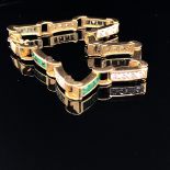 AN 18k STAMPED EMERALD AND DIAMOND LINE BRACELET. EACH CHANNEL SET PANEL MADE UP OF ALTERNATING