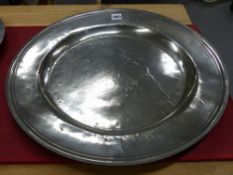 AN 18th C. PEWTER CHARGER, THE RIM INITIALLED P OVER R E. Dia. 51cms.