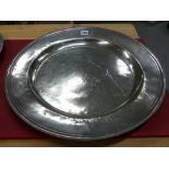 AN 18th C. PEWTER CHARGER, THE RIM INITIALLED P OVER R E. Dia. 51cms.