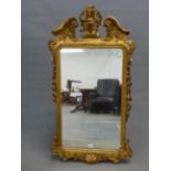 AN 18th.C. STYLE RECTANGULAR MIRROR, THE GILT FRAME WITH FOLIAGE CENTRED BROKEN ARCH PEDIMENT,