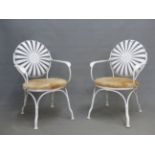 A PAIR OF FRANCOIS CARRE SPRUNG WHITE PAINTED IRON ELBOW CHAIRS WITH SUNBURST CIRCULAR BACKS AND